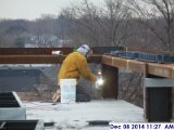 Welding metal clips along the low roof facing North.jpg